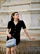 A pretty girl wears a black dress